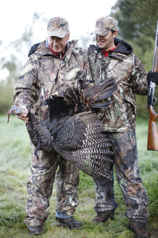 Two men with a large turkey
